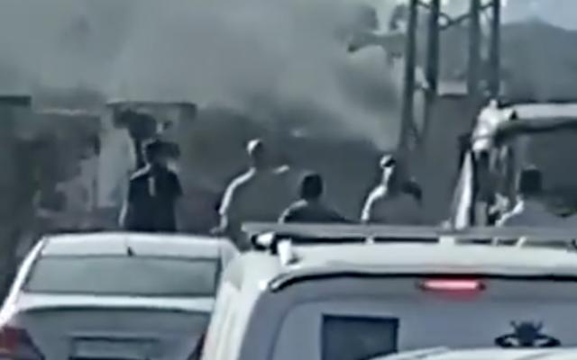 Smoke billows during a reported settler attack in the Palestinian West Bank village of Yabrud, October 13, 2025. (Screen capture: X/Palestinian Information Center)